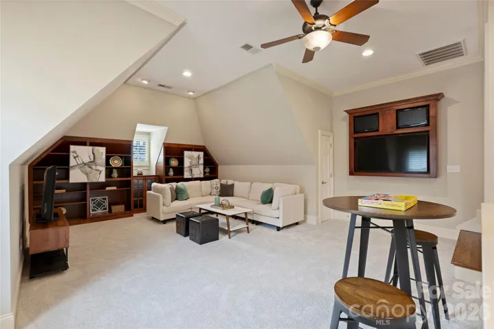 Oversized bonus room with built in cabinetry and access to downstairs 