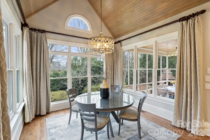 Stunning, light-filled breakfast area overlooking backyard and screened in porch