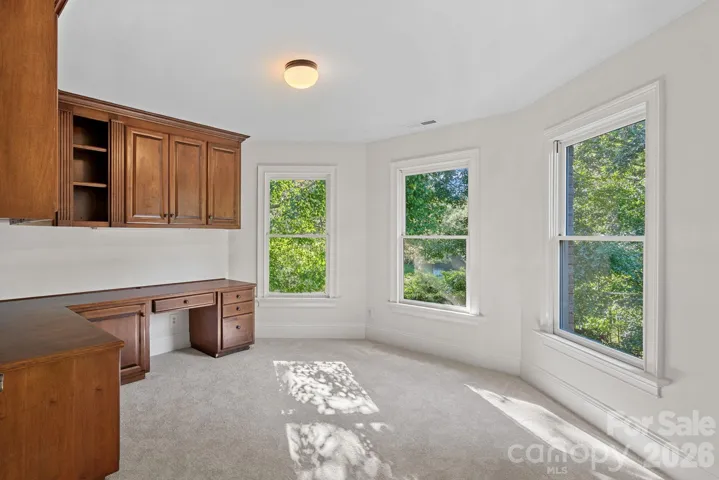 One bedroom currently set up as an office with custom built in shelving. 