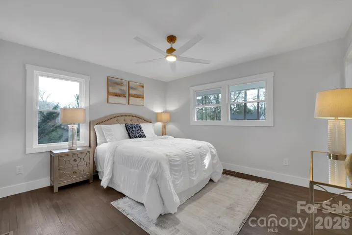 Primary Bedroom – Inviting primary suite with generous natural light, hardwood floors, and a ceiling fan for year-round comfort.
