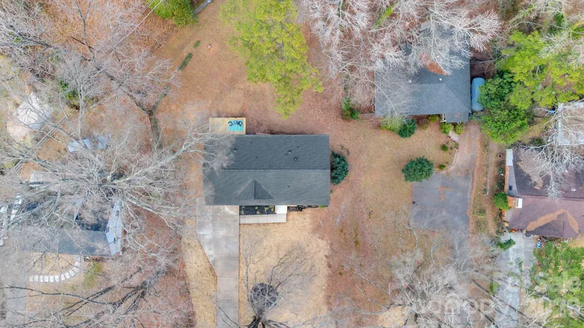Aerial View – Overhead perspective highlighting the home’s footprint, driveway, and expansive lot.
