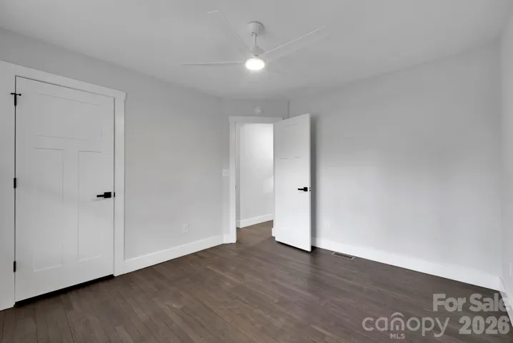 Bedroom (Alternate View) – Spacious layout with modern ceiling fan, updated trim, and ample wall space for flexible furniture placement.