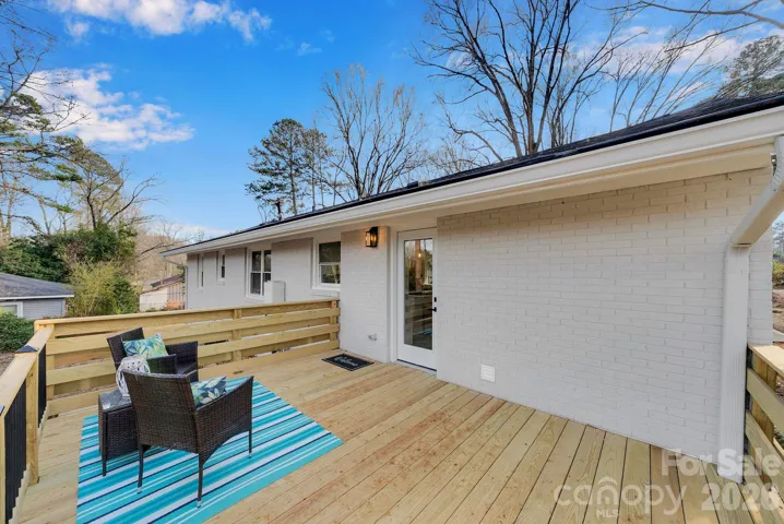 Rear Deck – Newly constructed wood deck with railing, ideal for outdoor seating and casual gatherings.