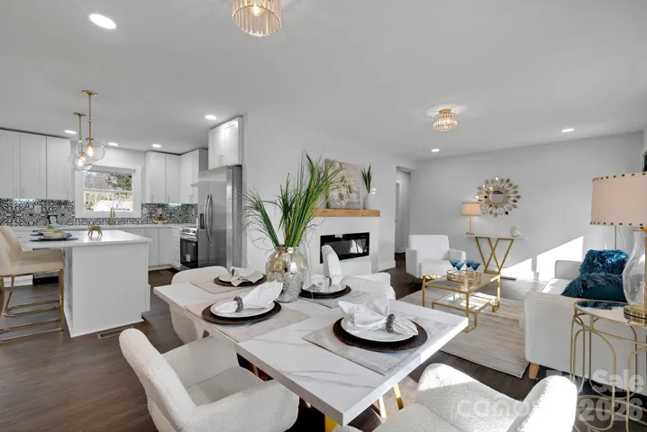 Dining Area & Living Room – Open-concept layout seamlessly connects the dining space and living room, highlighted by contemporary lighting and stylish accent wall detailing.