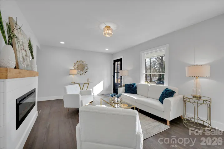 Living Room (Alternate View) – Sunlit seating area with oversized windows and designer finishes, perfect for relaxing or entertaining guests.