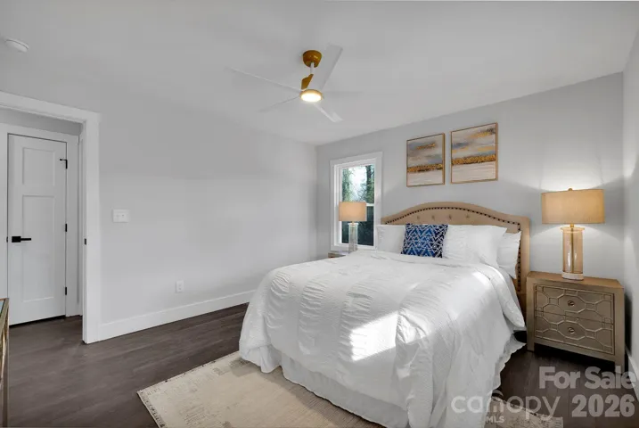 Primary Bedroom (Alternate View) – Well-proportioned primary bedroom with updated ceiling fan, hardwood flooring, and a calming neutral palette.