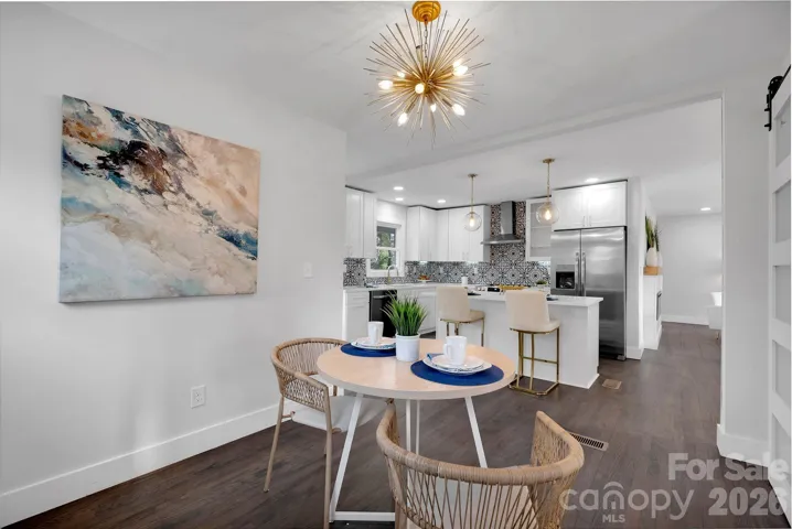 Dining Area – Dedicated dining space accented by statement lighting and an open flow into the kitchen, ideal for everyday meals or entertaining.