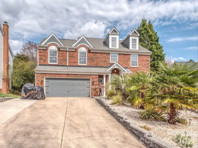 Brick front home with extended driveway