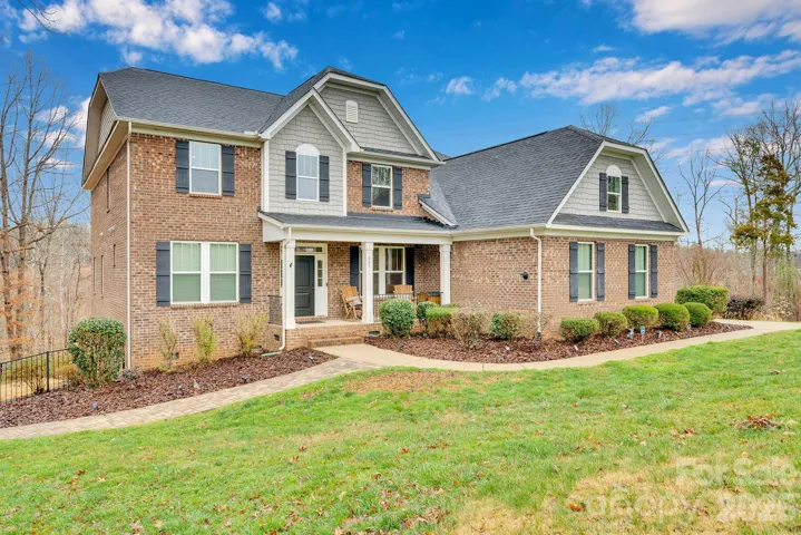 Welcome to 663 Highland Ridge Point, where classic brick architecture meets expansive acreage and a setting that reflects both presence and privacy near Lake Wylie.