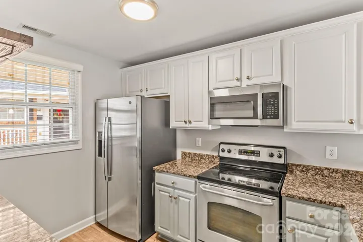 Kitchen featuring stainless streel appliances and granite countertops.