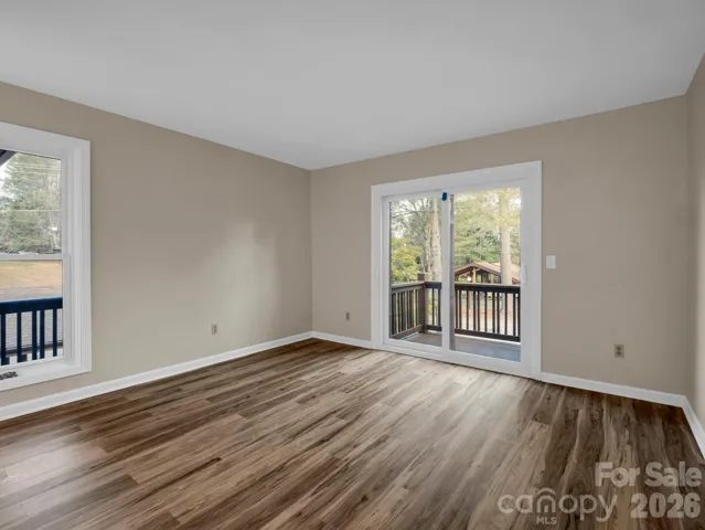 Living area with access to outdoor porch and storage closet.
