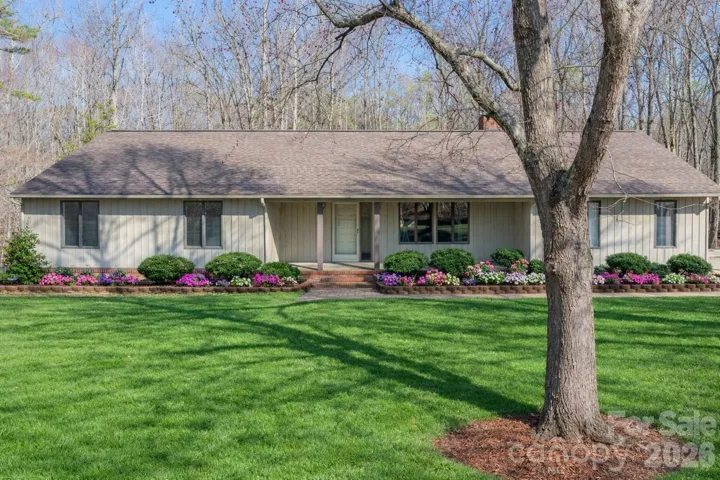 Front of home, grass and flowers virtually staged