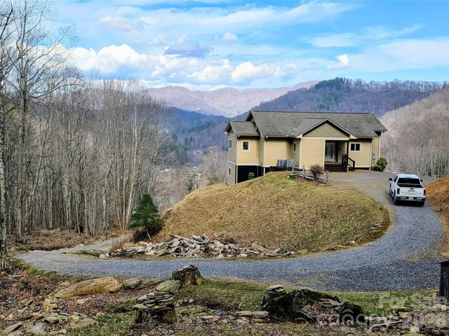 View of house, circular drive and mountain view