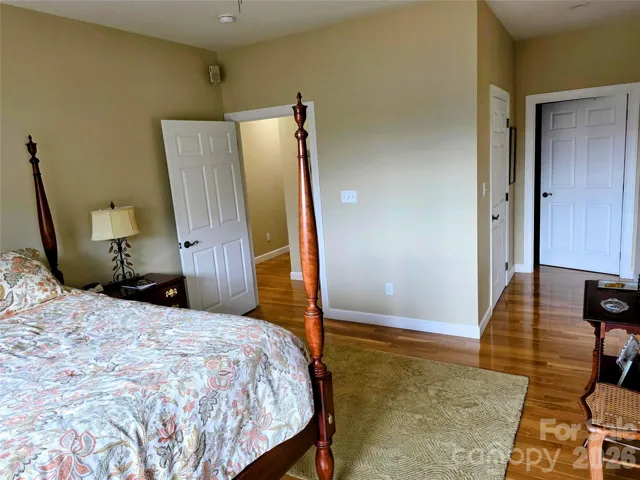 Primary bedroom with large walk-in closet behind partially open door