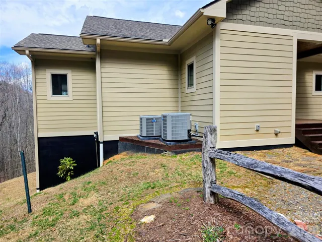 View of rear of house showing dual zone HVAC units