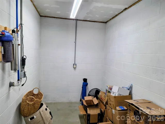 Water line entering lower level storage space with UV filter and regular cartridge filter