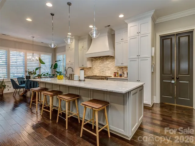 The Gourmet Kitchen Features Quartz Island, Gas Range & Double Oven, Custom Vent Hood, Recessed & Pendant Lighting, Built-In Fridge, Hidden Pantry, & MORE!