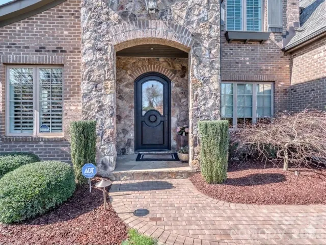 The paver walkway guides you as you are welcomed by the covered front entry way!