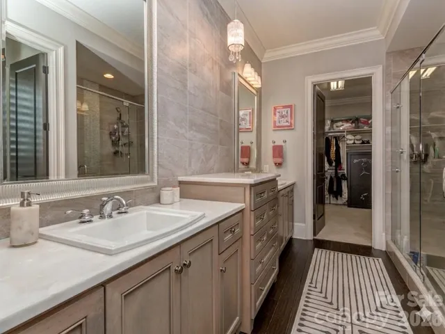 Primary Bath with Custom Dual Vanity, Individual Framed Mirrors, Tile to Ceiling Backsplash, Huge Walk-In Shower, Water Closet, & Oversized Walk-In Primary Closet.