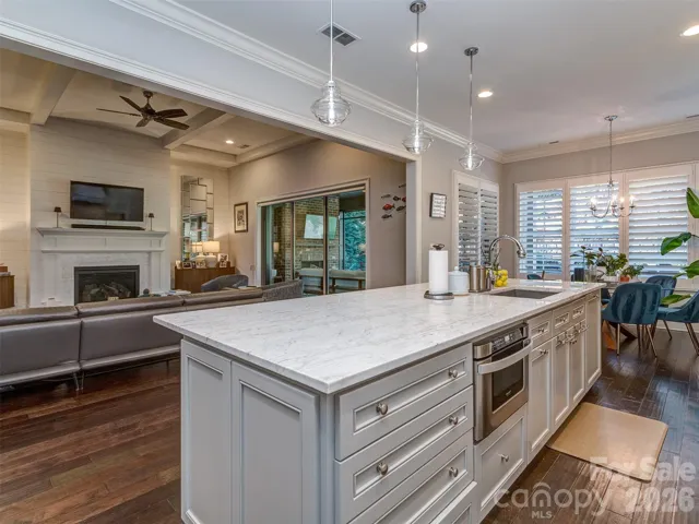 The Gourmet Kitchen Features Quartz Island, Gas Range & Double Oven, Custom Vent Hood, Recessed & Pendant Lighting, Built-In Fridge, Hidden Pantry, & MORE!