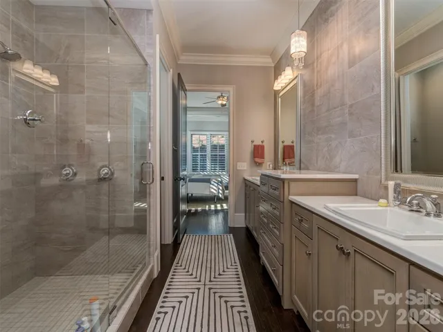 Primary Bath with Custom Dual Vanity, Individual Framed Mirrors, Tile to Ceiling Backsplash, Huge Walk-In Shower, Water Closet, & Oversized Walk-In Primary Closet.