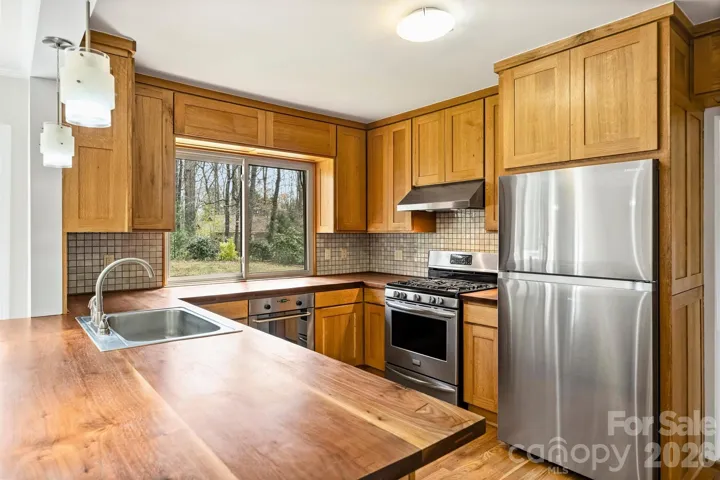 Custom white oak kitchen cabinets with solid walnut countertops.