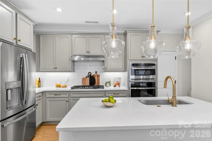 Kitchen with upgraded lights and champagne bronze fixtures