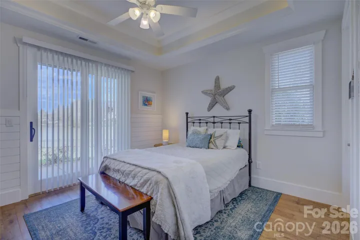 Bedroom #2 with hardwood floors, walk-in closet, and waterview.