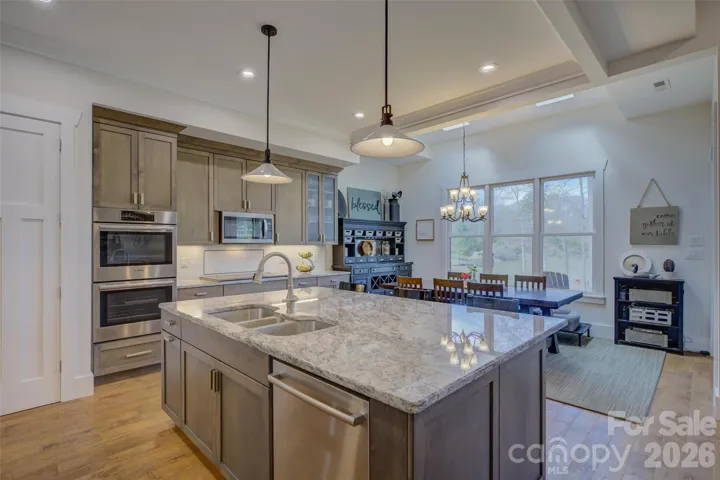 Cook's Kitchen with granite countertops and large sitting island.