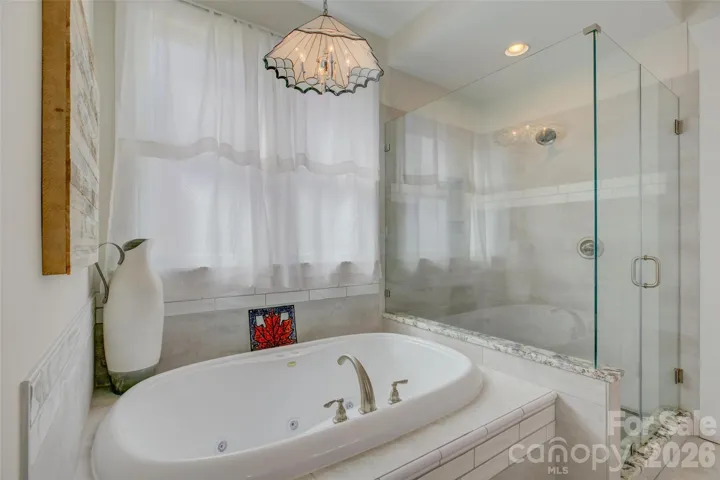 Primary Bath with soaking tub and corner glass shower.