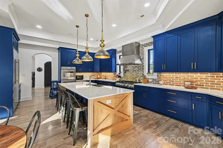 Custom Cabinetry in the kitchen is beautifully crafted and the massive island is perfect for entertaining