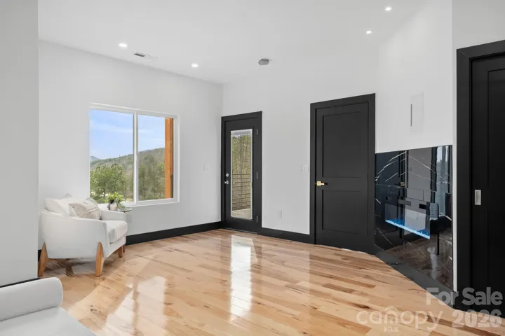 Primary bedroom seating area and electric fireplace 