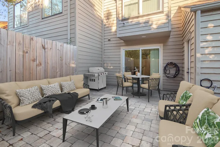 Virtually staged to show potential — private fenced patio with extensive hardscaping.