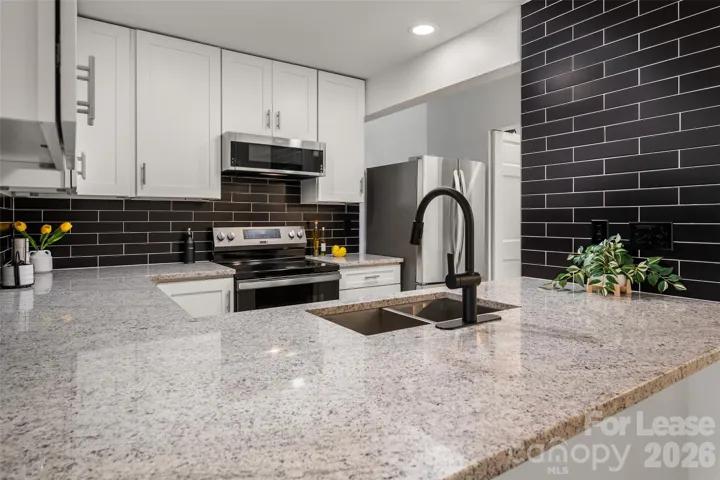 Updated kitchen with modern finishes and ample counter space