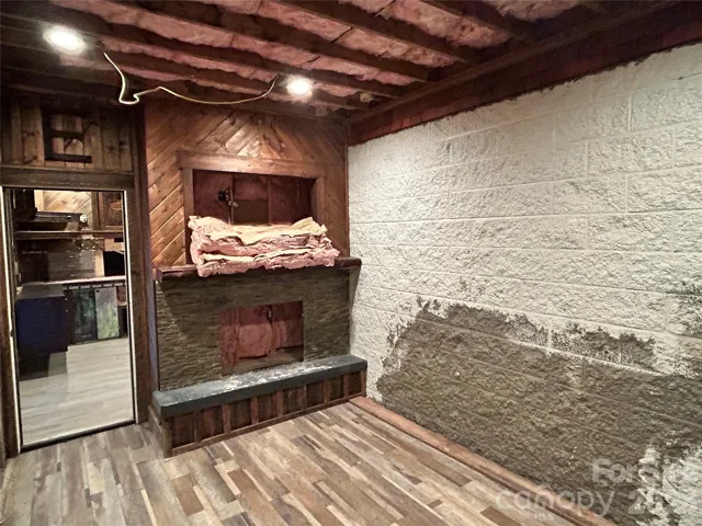 Unfinished gas fireplace room in basement