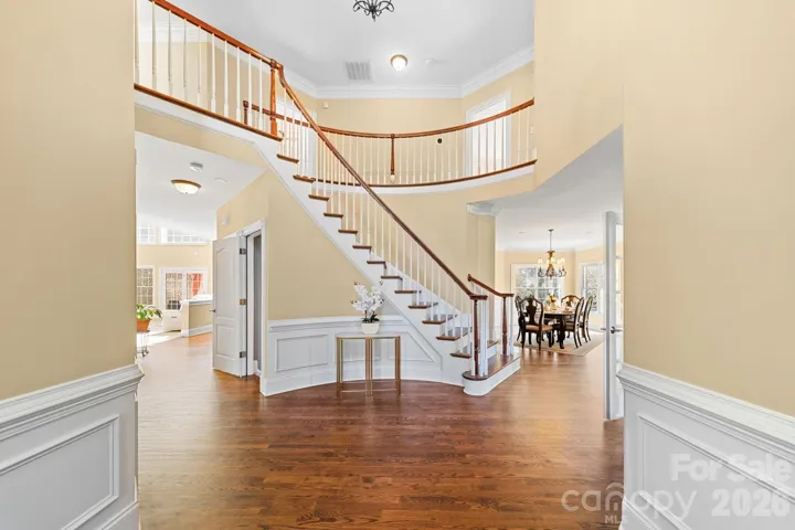 Breathtaking two-story foyer welcomes you with rich hardwood floors, elegant trim work, and a sweeping staircase that sets the tone for this stunning luxury residence