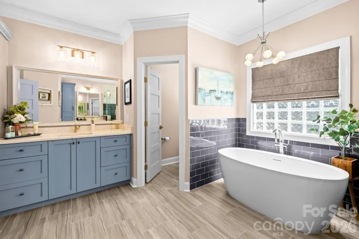 Amazing remodeled primary bathroom is a welcome retreat from a long day.