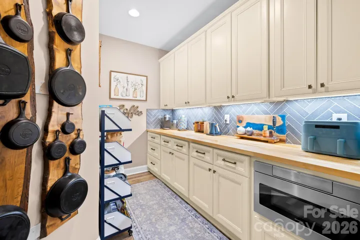 Check out this awesome butler's pantry offering plenty of storage and serving space.