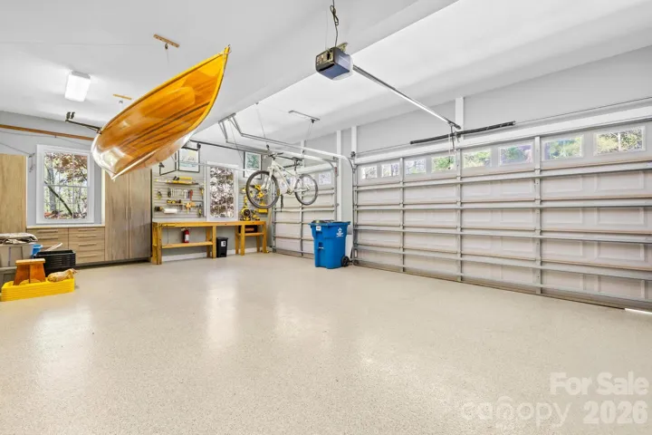 Garage is immaculate with epoxy floor, workbench and cabinets.