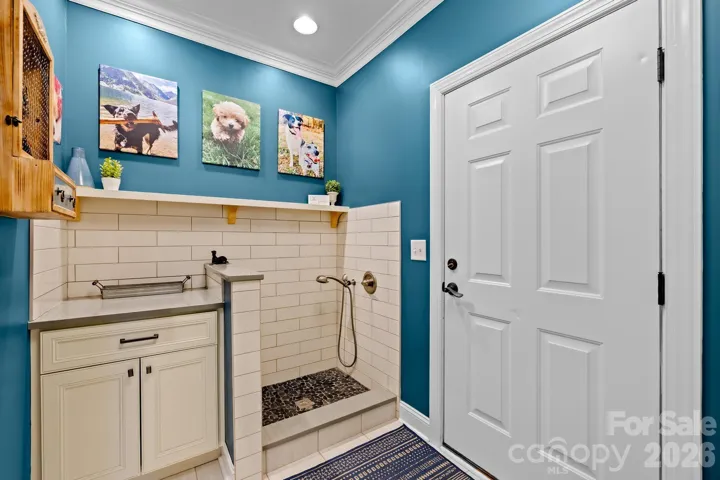Drop zone, mud room and dog bath off garage hallway and driveway side entrance. 