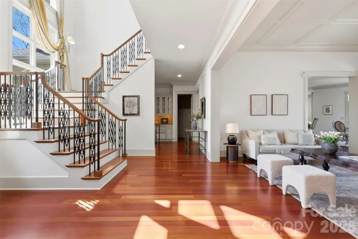 The foyer is where Frank Lloyd Wright shows up. Curved staircase, soaring ceiling, Brazilian cherry hardwood floors.