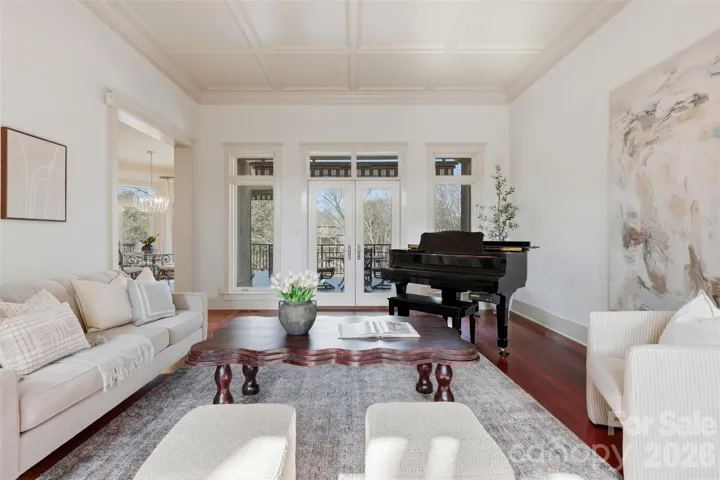 Curved walls, grand piano, natural light from three directions. This room does not feel like a living room, it feels like a statement.
