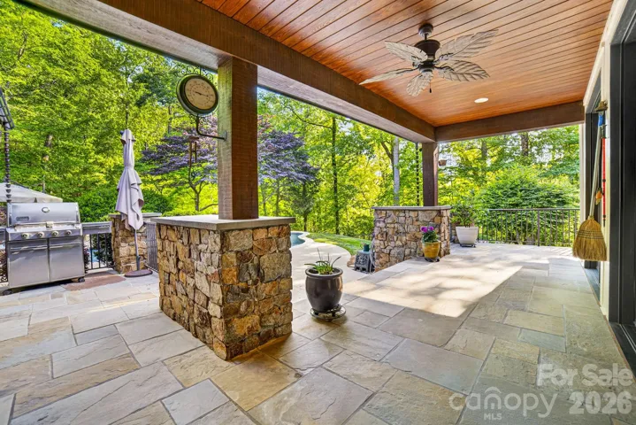 There are covered bluestone porches at the front and side entrances and across the back of the home with beadboard ceilings and recessed lighting and wall sconces.