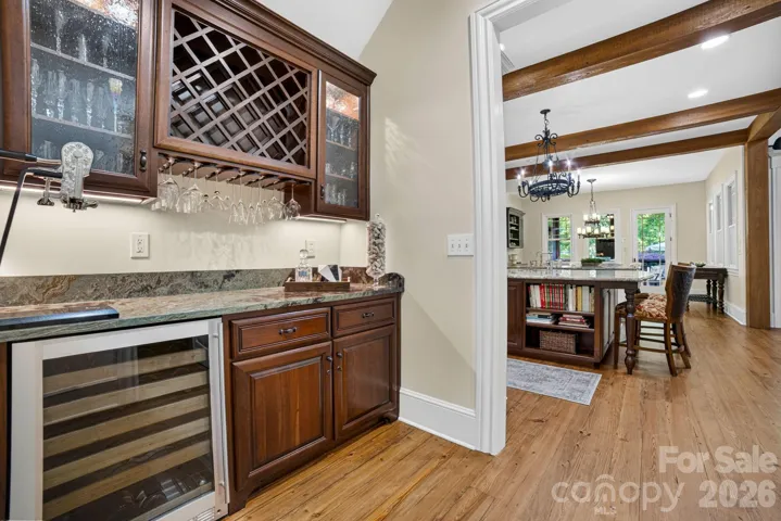 The Butler’s Pantry has a beautiful marble counter top, a built-in wine chiller and tear drop glass cabinets for showcasing favorite cocktail glassware.