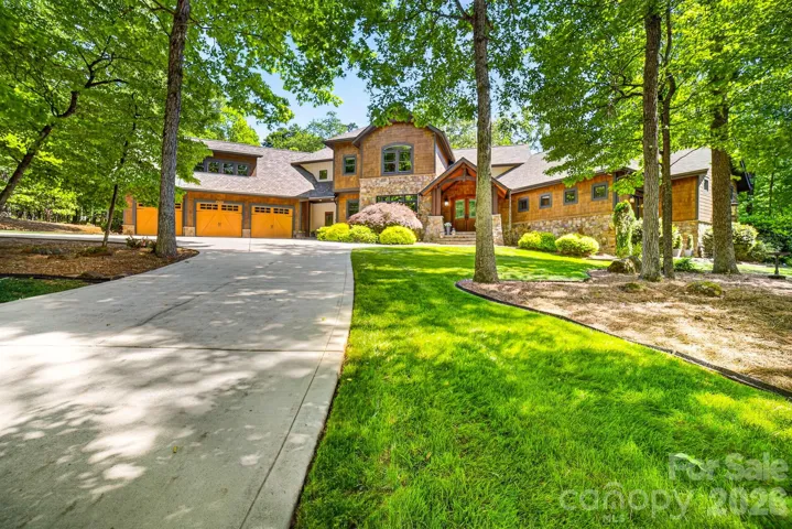Welcome to this rare, serene retreat on four acres of mature hardwoods and curated landscaping. Located within Stillwell—an exclusive gated enclave of just 36 luxury homes—this property offers both privacy and proximity to Lake Norman, nature preserves, and premier schools.