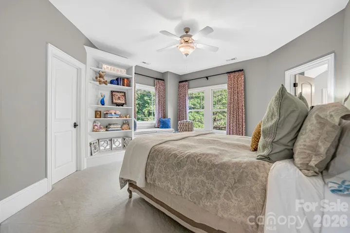 This lovely bedroom enjoys a built-in bookcase,-in closet, window seat with large picture window, and ensuite bathroom.