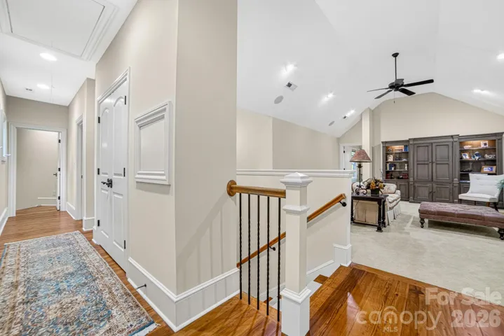 At the top of the stairs, a Loft overlooks the Great Room and impressive hammer beam trusses. Current owners use it as the LP listening, board game/ jig saw puzzle room. The hallway leads to the laundry chute (to the Laundry Room), two bedrooms and the Rec room.