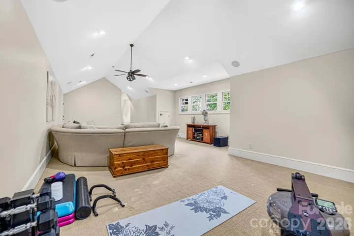 Plenty of room for exercise equipment and a game table with plenty of natural light
