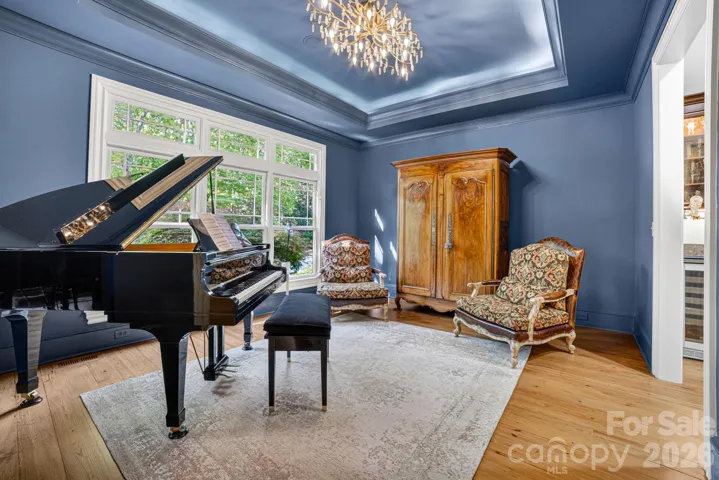 The dining room which serves as the music room has statement lighting and lots of natural light