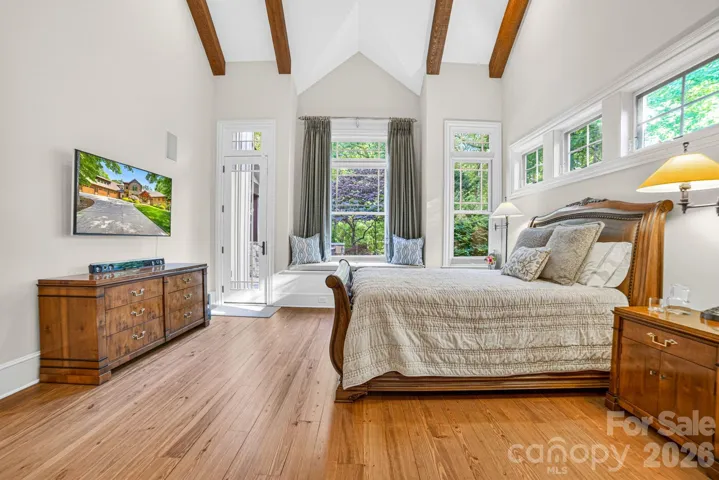 The primary bedroom and bathroom – The primary bedroom is a beautiful retreat for early morning bird watching and evening stars, from the window seat with storage to relaxing in bed. The vaulted ceiling with cypress beams and beautiful architectural aspects make this a room a special place!